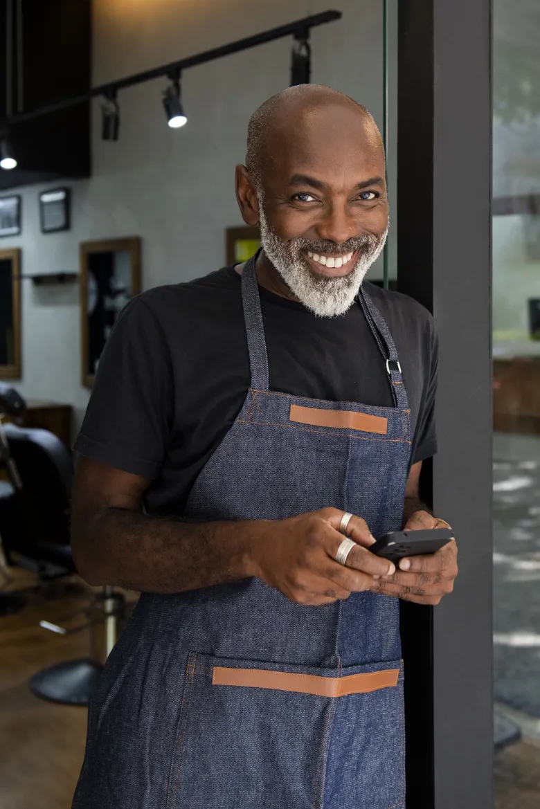 A happy small-business owner using a product TeniVision designed and built